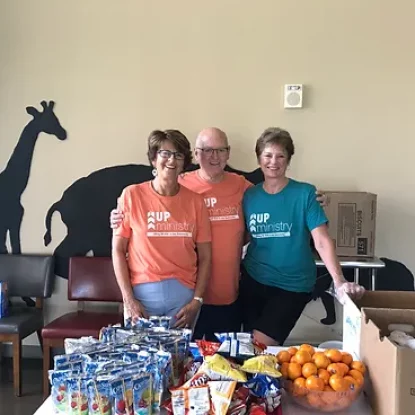 Volunteers With Snack Donations